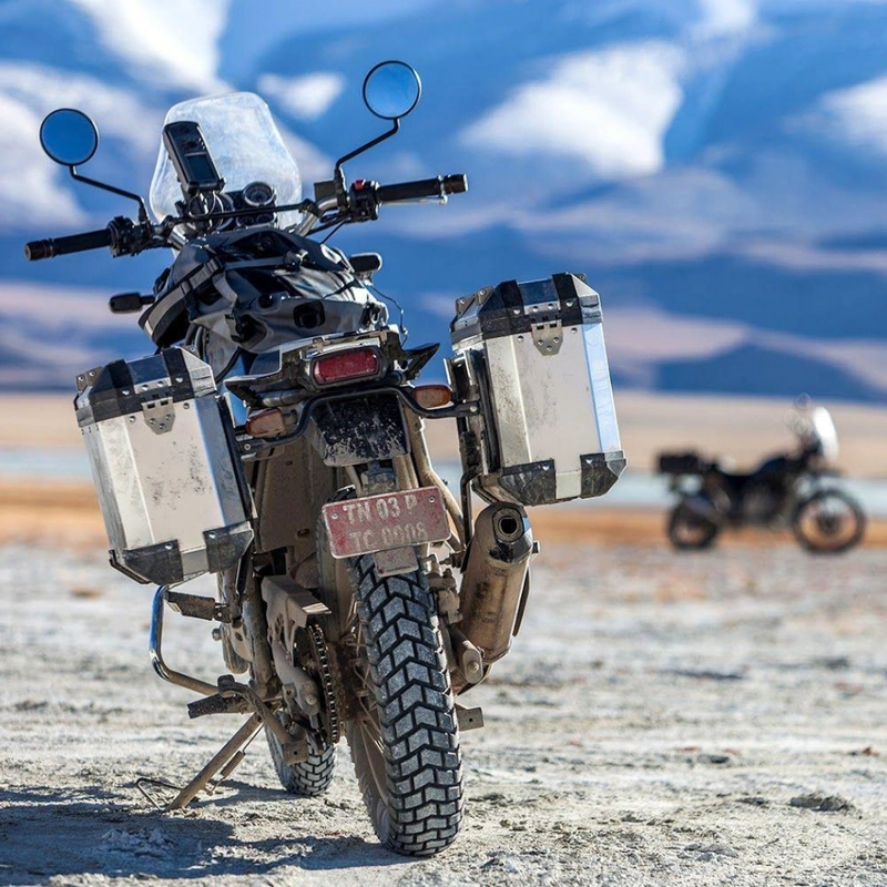 Image of two royal enfield himalayan fitted with spoke tyres standing on mountain