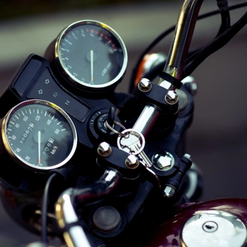 Image of motorcycle handlebar with key fitted in the ignition cylinder