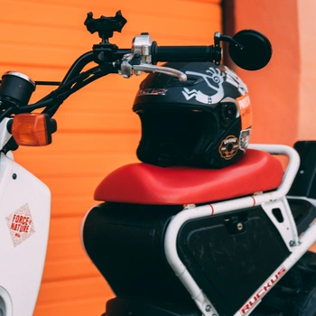 Image of a red scooter with phone holder mounted on the handlebar