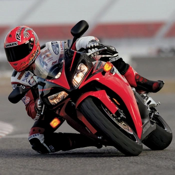 Image of a professional racer performing knee dragging and wearing knee protector