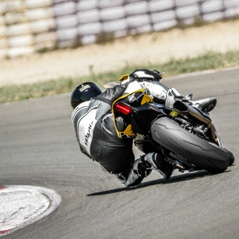 A motorcycle racer knee dragging with lean angle on corner of track
